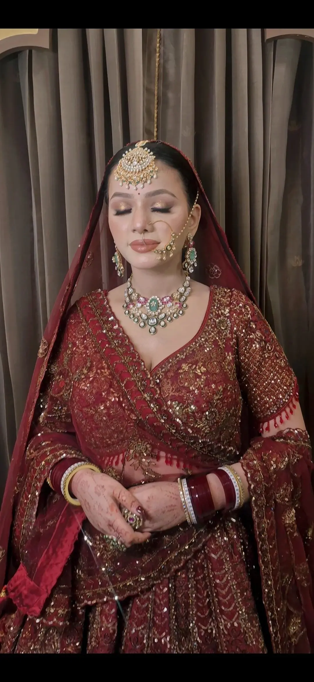 Indian bridal makeup with luminous skin, defined eyes and a refined red bridal look by Priyanshi in Roorkee