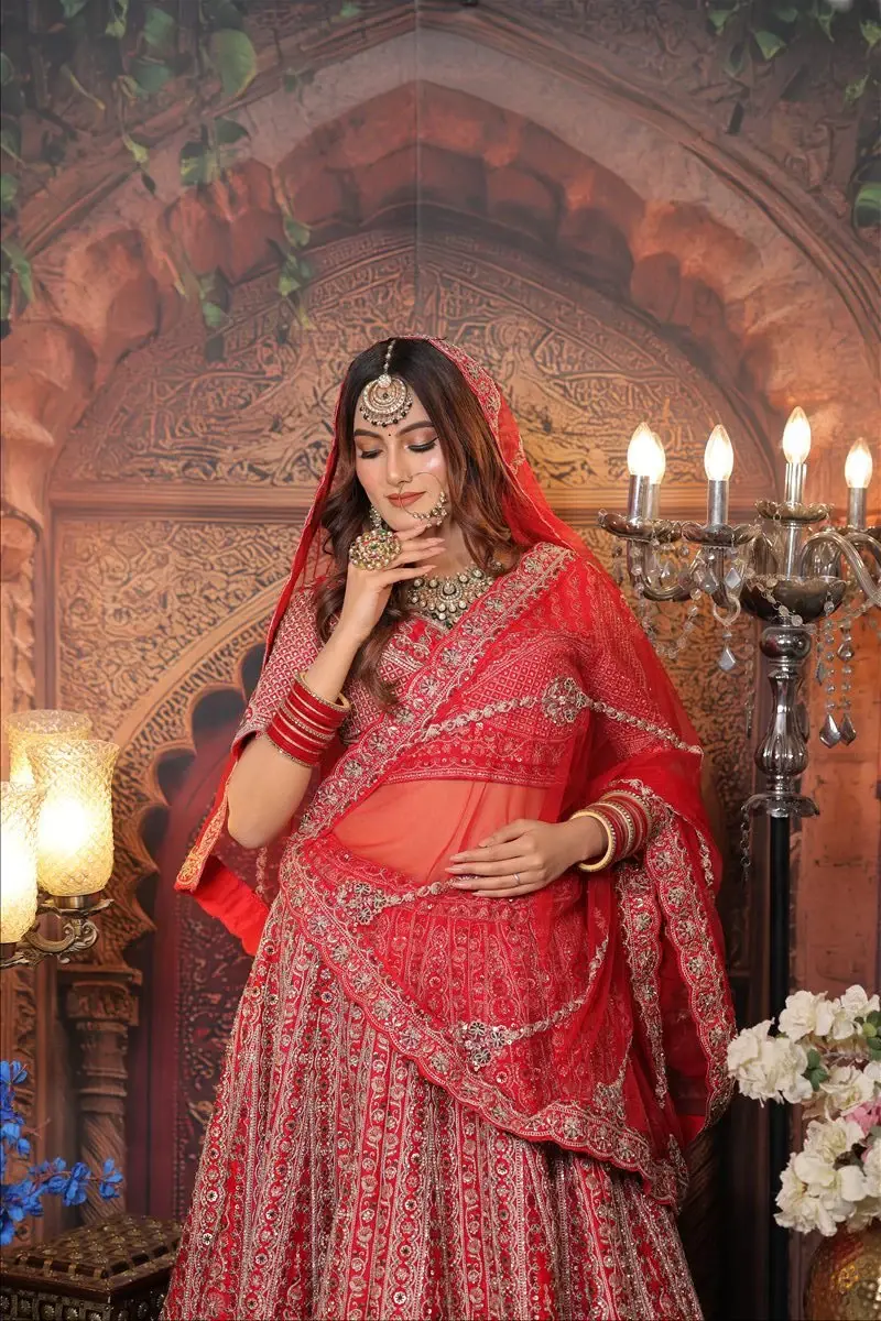 Indian bridal makeup with luminous skin, defined eyes and a refined red bridal look by Priyanshi in Roorkee