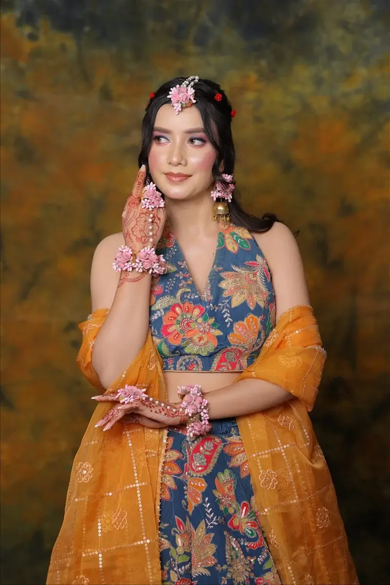fresh Haldi and Mehendi makeup with floral jewellery and a joyful finish by Priyanshi in Roorkee