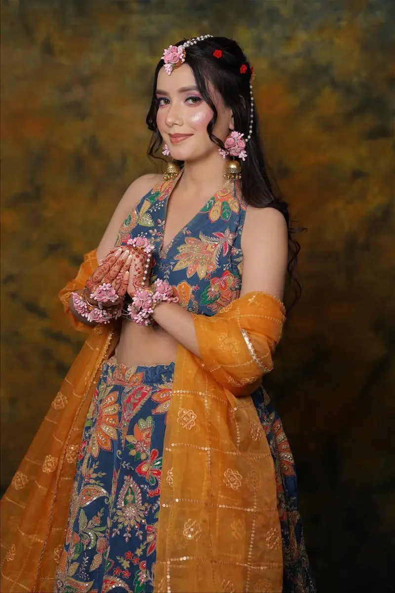 fresh Haldi and Mehendi makeup with floral jewellery and a joyful finish by Priyanshi in Roorkee