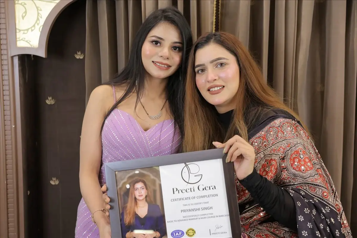 Priyanshi receiving her professional makeup course certificate from Preeti Gera